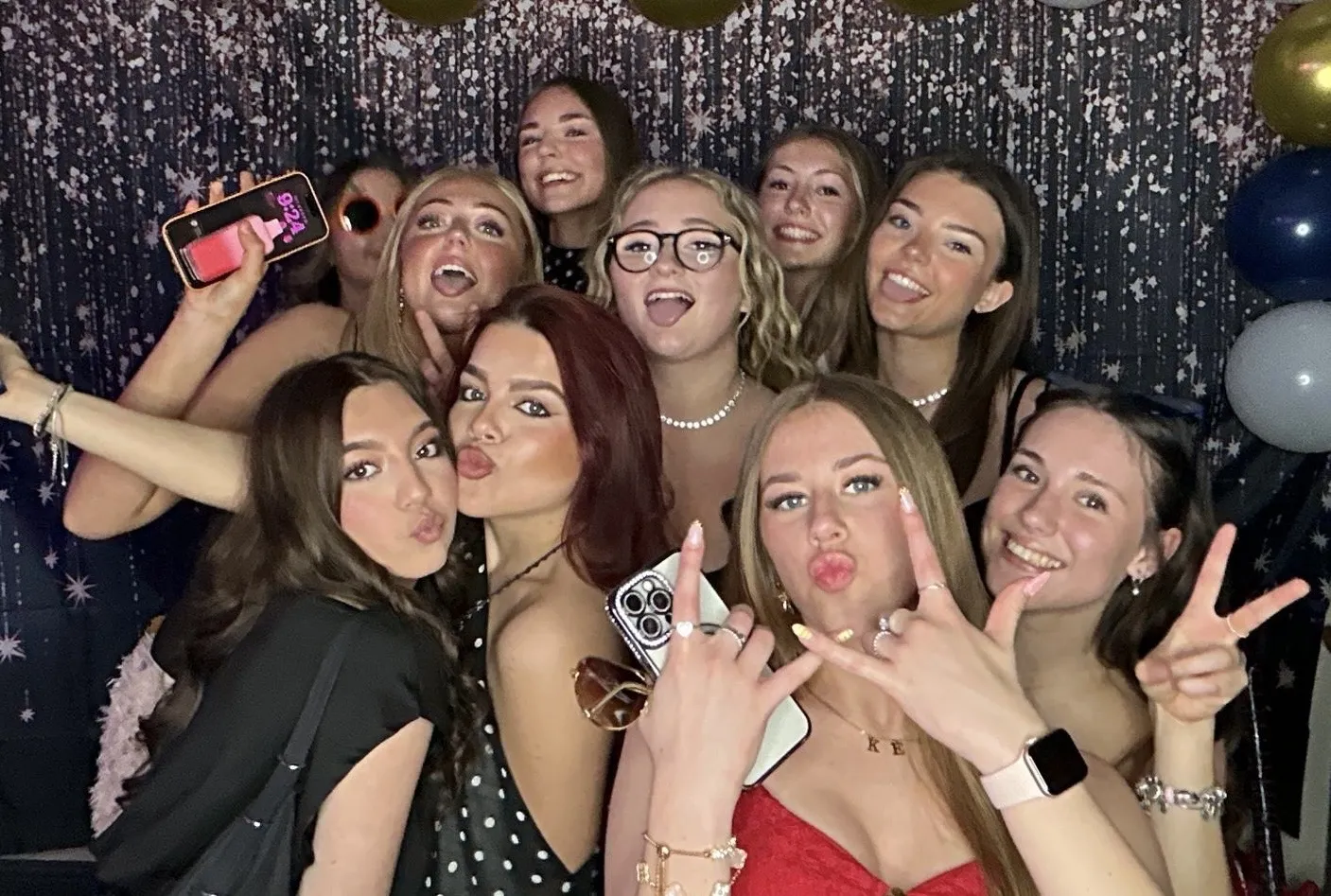 Guests using the DJ Paul Davies photo booth hire against a sparkle backdrop