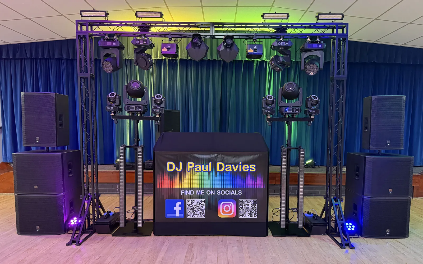 Mobile disco lighting rig and DJ booth set up in a Cambridgeshire village hall